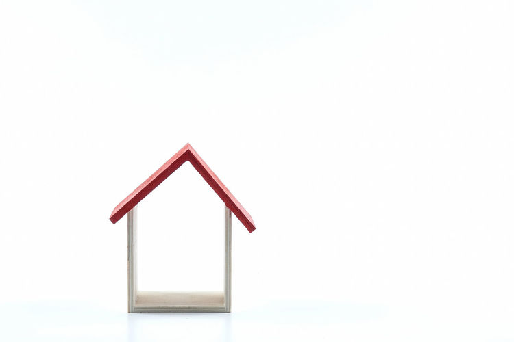 Close-up of red house against white background