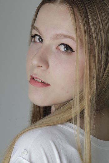 Close-up portrait of a beautiful young woman looking away