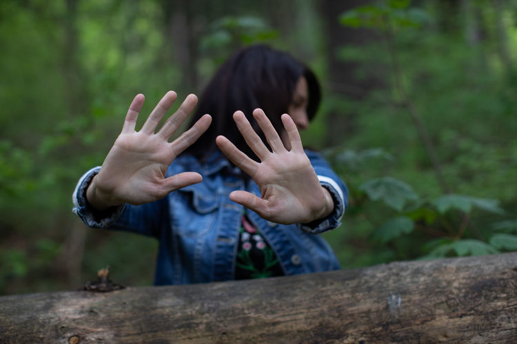Woman showing her hands in forest