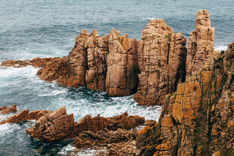 Rocks on shore by sea