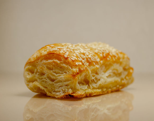 Close-up of bread on table against white background