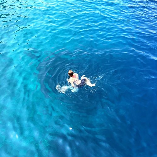 High angle view ofman swimming in sea
