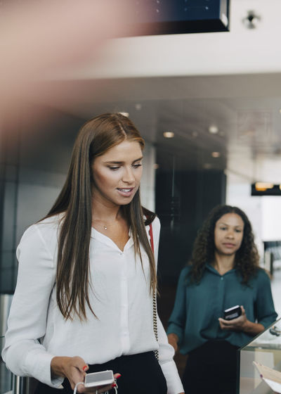 Young businesswoman going through check-in process at airport