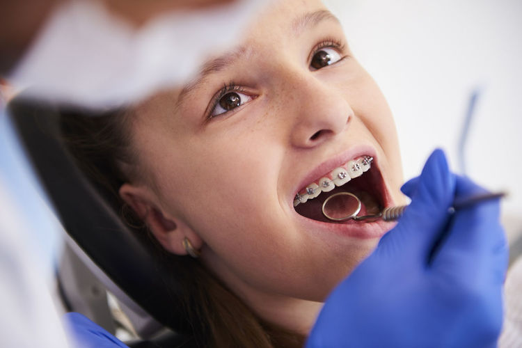 Dentist examining girl mouth in hospital