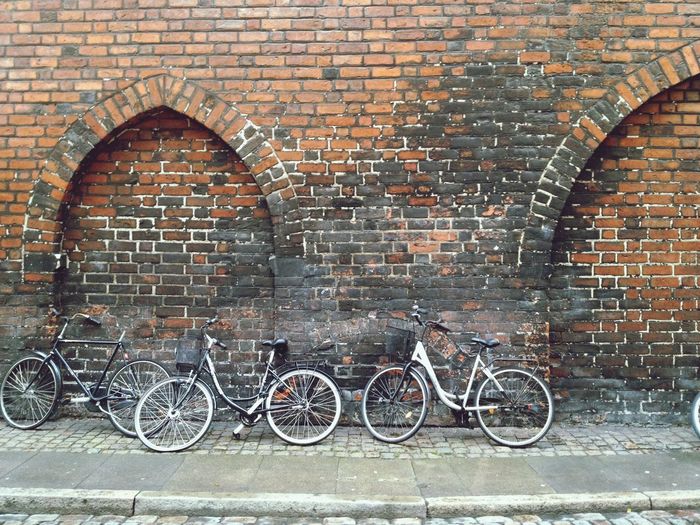 Bicycles against brick wall