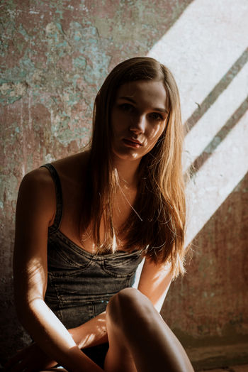 Model in Munich, Germany Dark Looking At Camera One Person Only Light And Shadow Long Hair Moody Sitting On Floor Underexposed Young Adult Young Woman