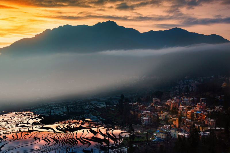 Scenic view of mountains against sky at sunset