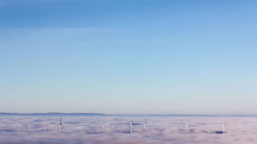 Scenic view of snowy landscape against clear blue sky