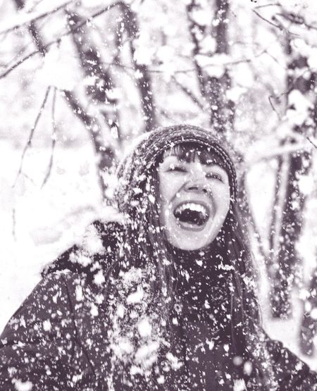 Happy woman during snowfall