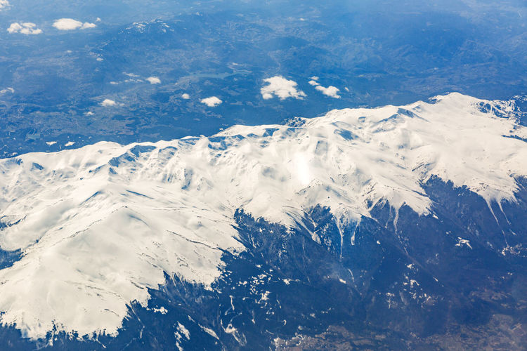 View from the window of the plane that flies over the mountains