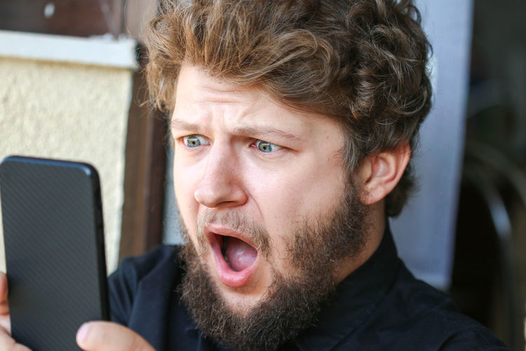 Close-up of man using smart phone
