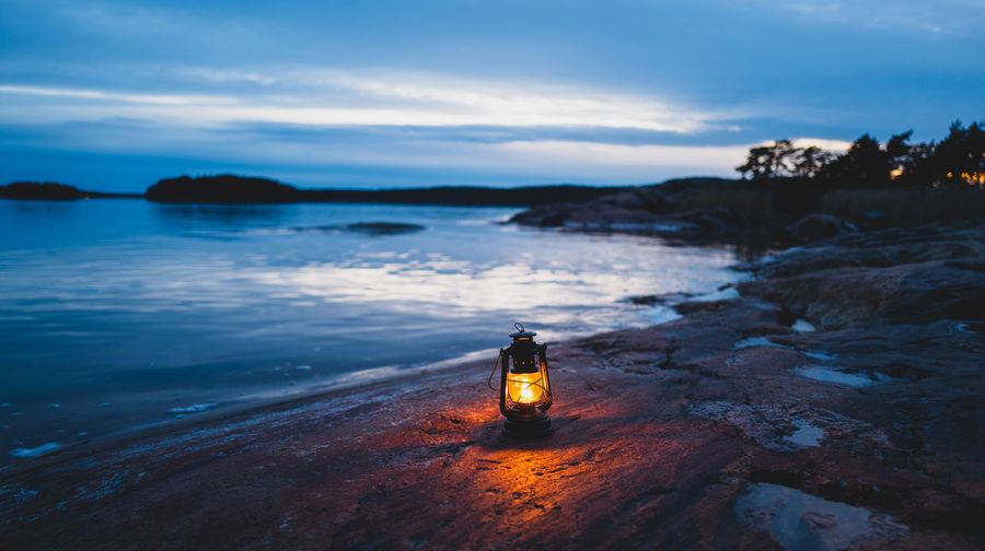 Illuminated lantern by sea