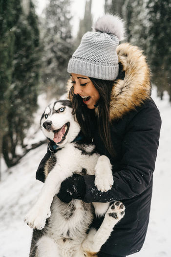 Young woman with dog in snow