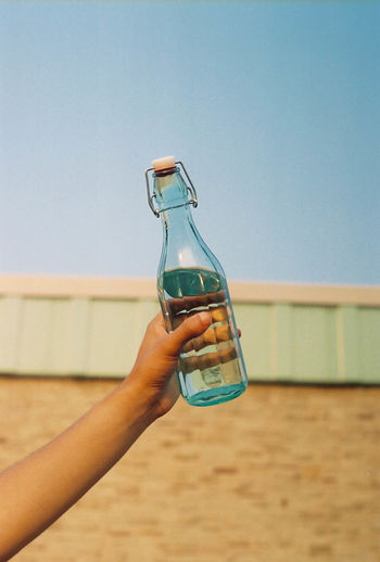Cropped hand holding water bottle