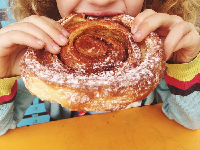 Close-up of girl eating pastry
