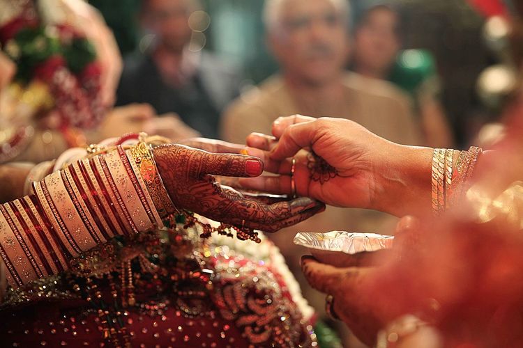 Cropped image of women performing ritual during wedding