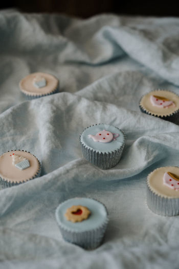 High angle view of cupcakes on fabric