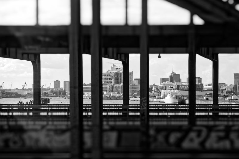 View of city buildings seen through bridge