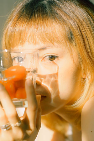 CLOSE-UP PORTRAIT OF A WOMAN WITH DRINKING GLASS