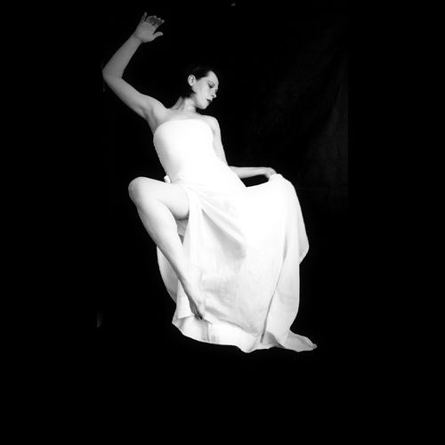 Woman levitating against black background