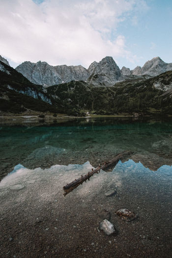 Scenic view of lake and mountains against sky
