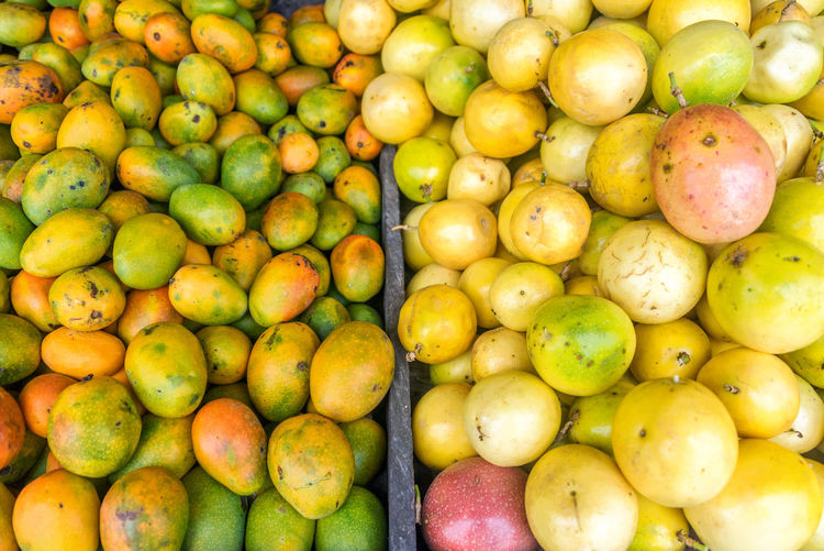High angle view of mangoes at market for sale