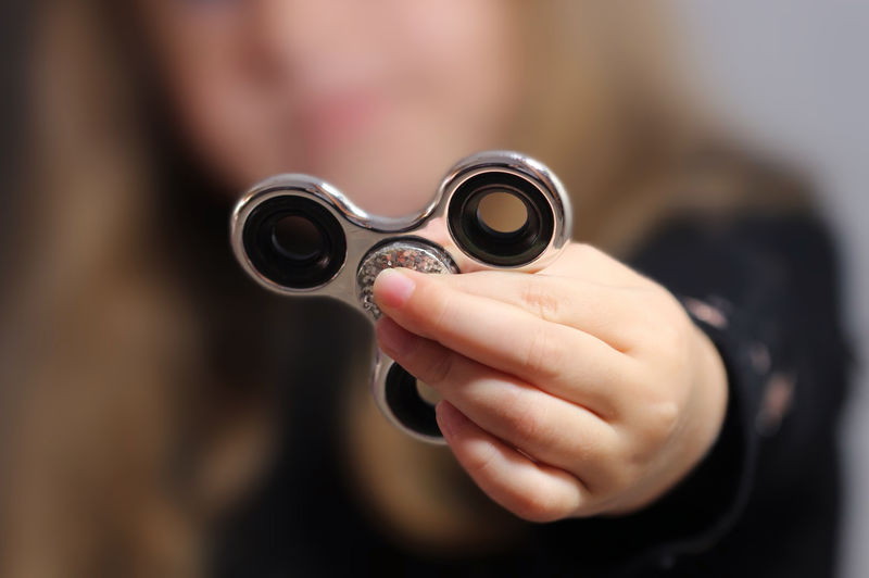 Close-up of girl holding fidget spinner