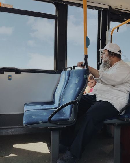 Man sitting on seat in train