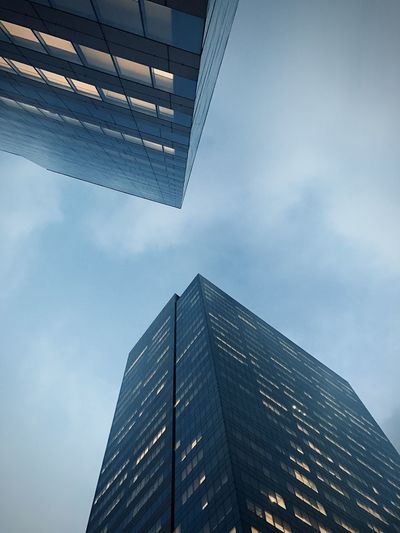 Low angle view of modern skyscrapers  against sky