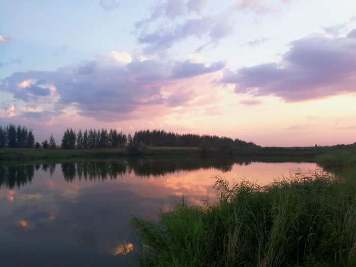 Scenic view of lake against sky during sunset