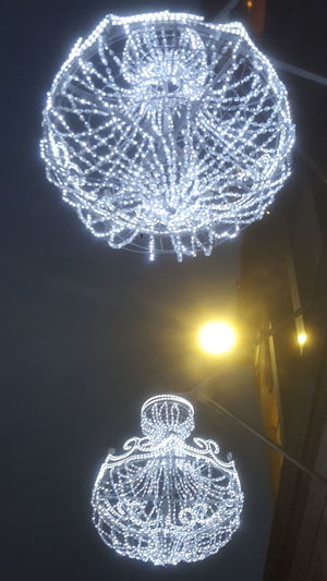 Low angle view of illuminated light hanging from ceiling