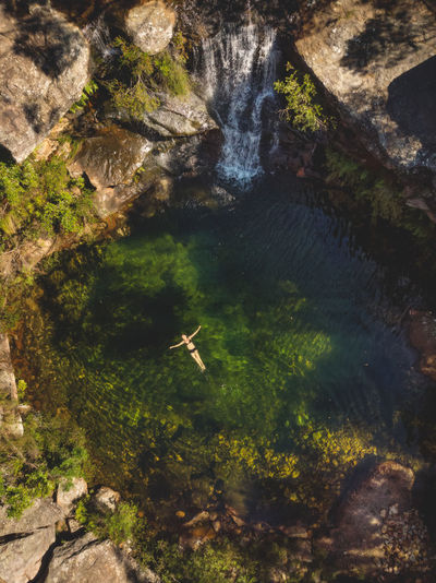 Aerial view of woman swimming in river