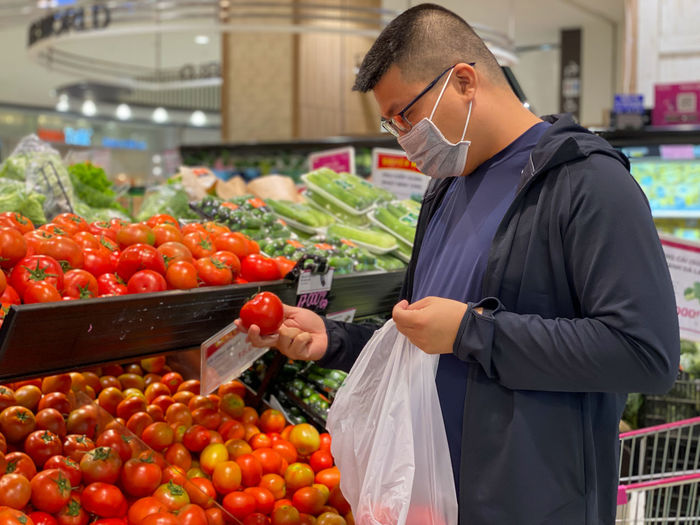 Man holding fruits in market