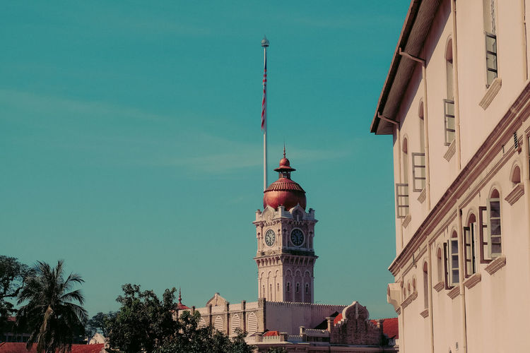 Low angle view of bell tower against blue sky