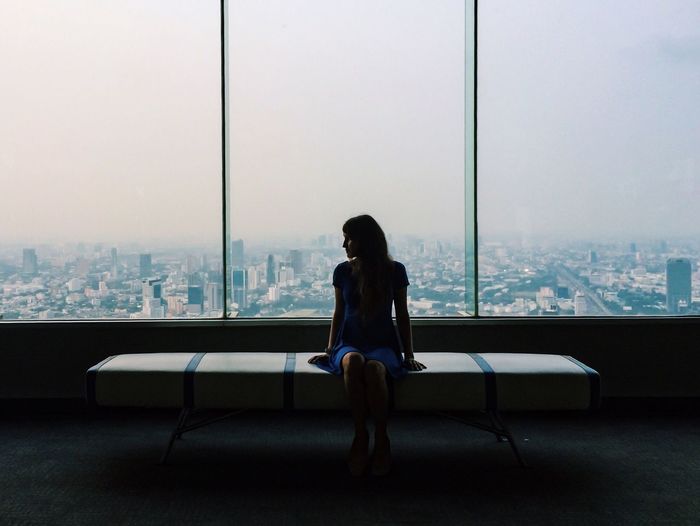 Rear view of woman looking at cityscape