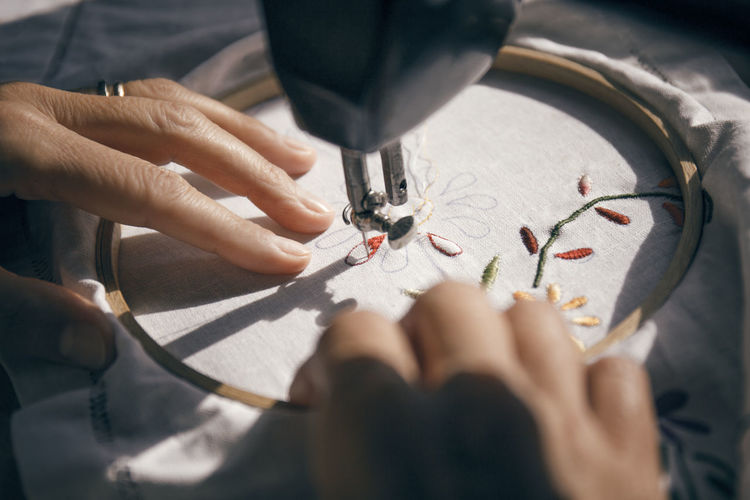 Cropped image of woman embroidering fabric