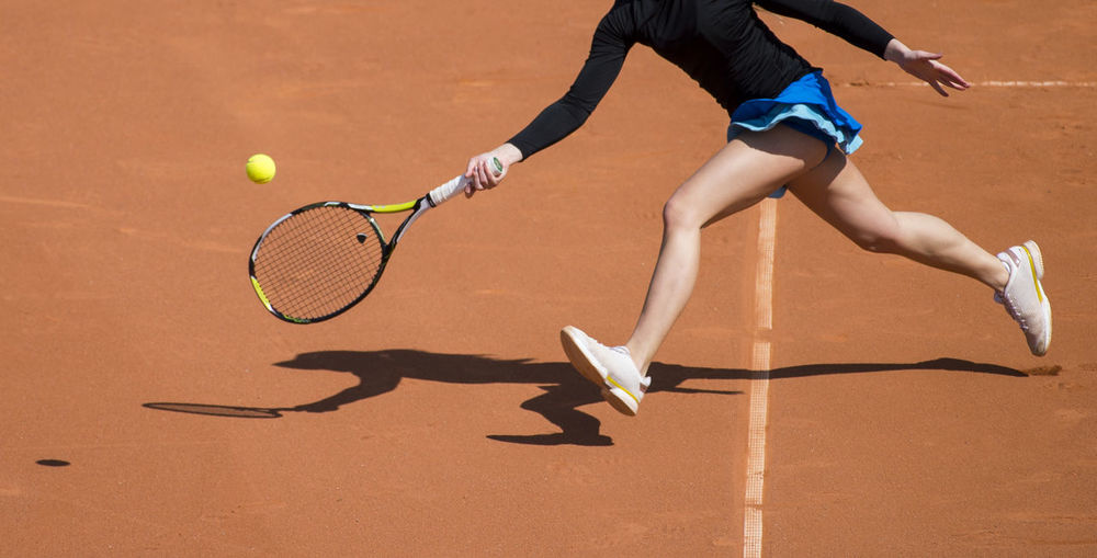Low section of woman playing tennis