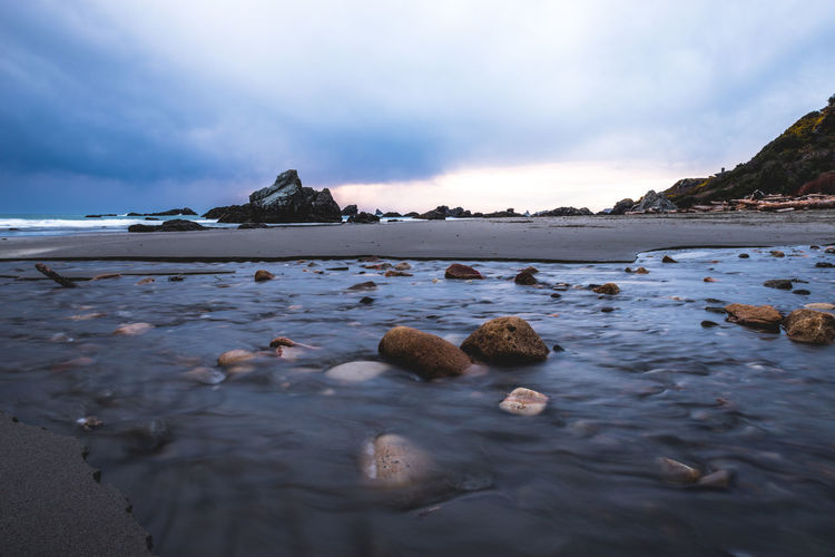 Scenic view of rock formation in sea against sky