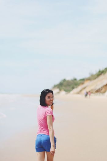 Portrait of woman standing on beach