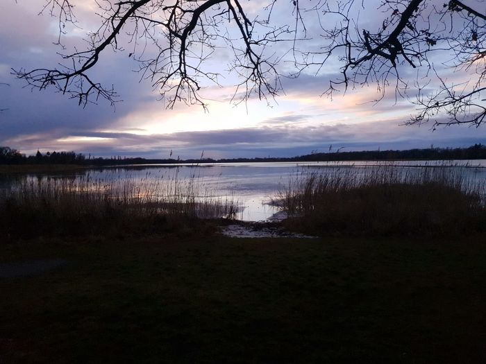 Scenic view of lake against sky during sunset