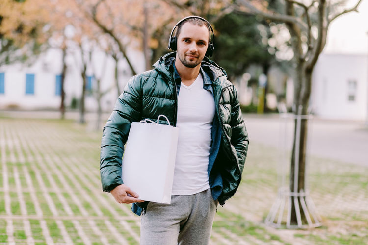 Portrait of man gesturing while standing outdoors
