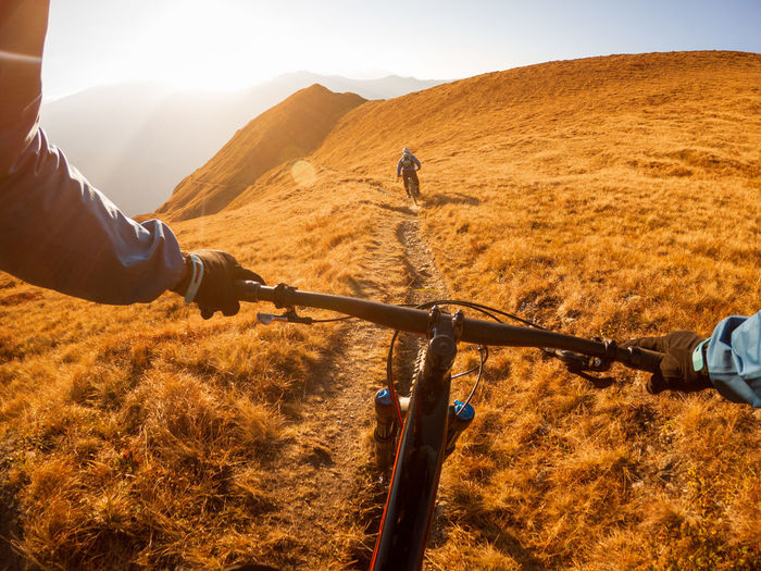 Cropped image of man riding bicycle on mountain
