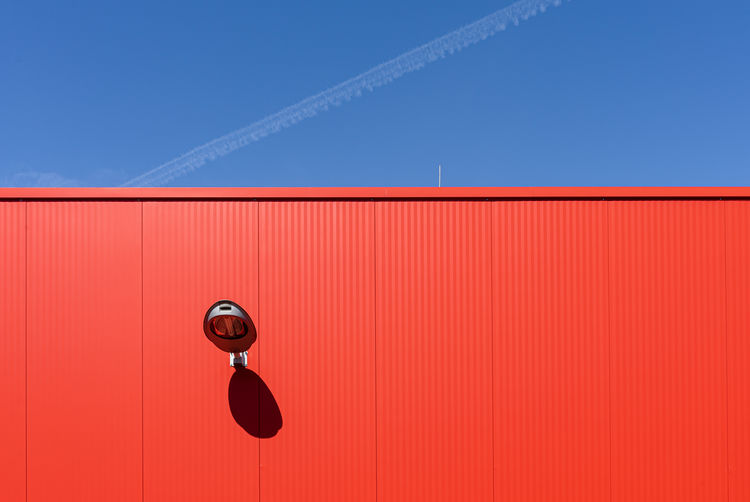 Low angle view of electric lamp against blue sky