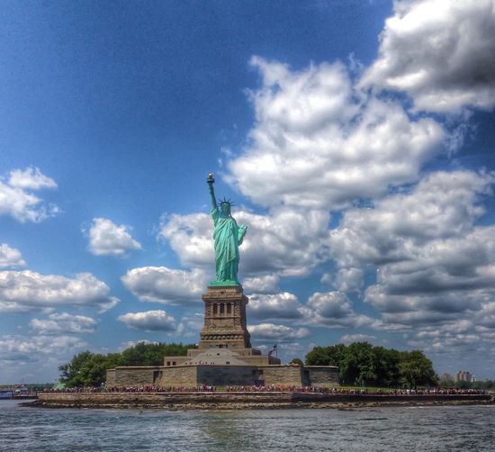Statue of liberty against cloudy sky