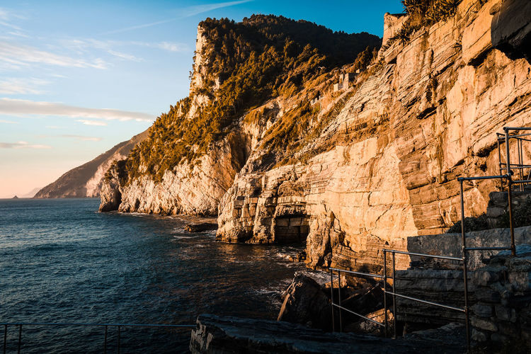 Rock formations by sea against sky