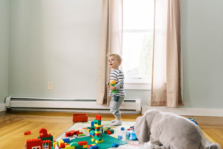 Midsection of child on floor at home