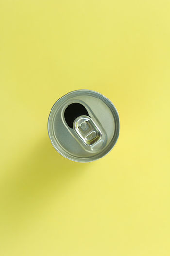 Directly above shot of empty glass against yellow background