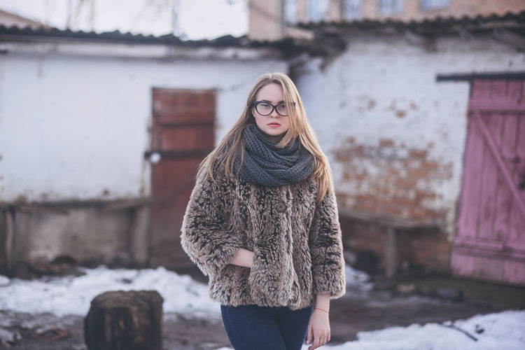 Portrait of woman standing in snow