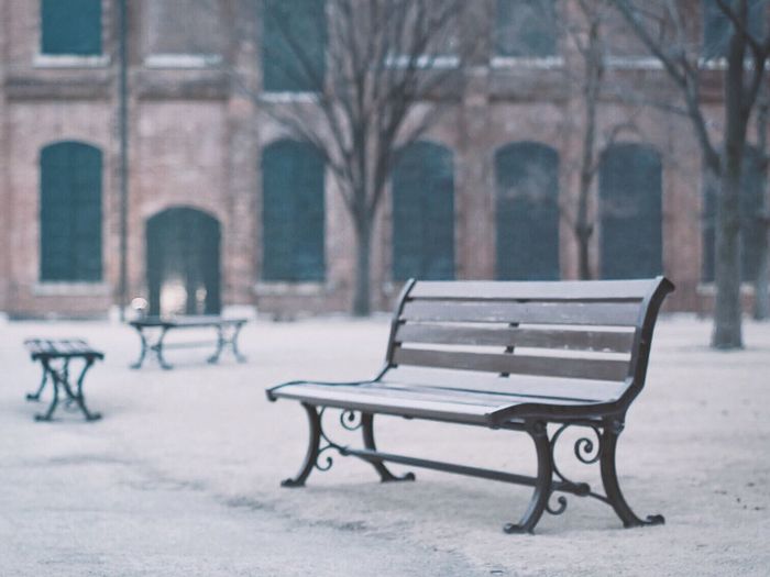 Empty benches in park during winter