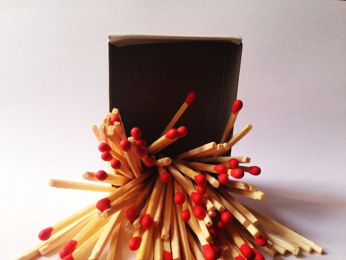 Close-up of matchsticks against white background